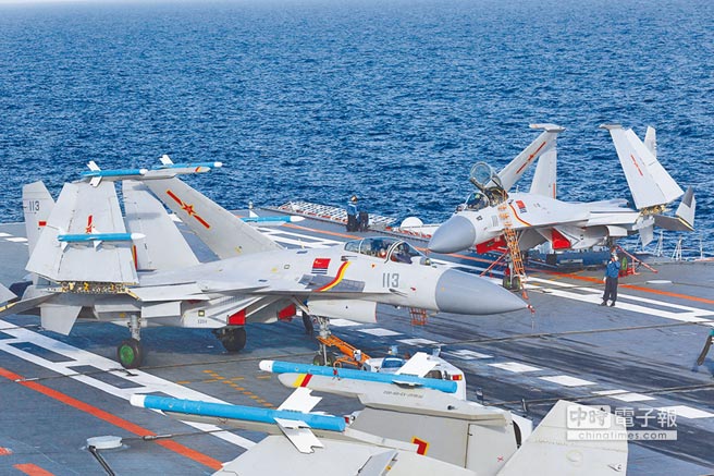 7月1日，2名工作人員在對飛行後的殲-15艦載戰鬥機進行狀態檢查。（新華社）