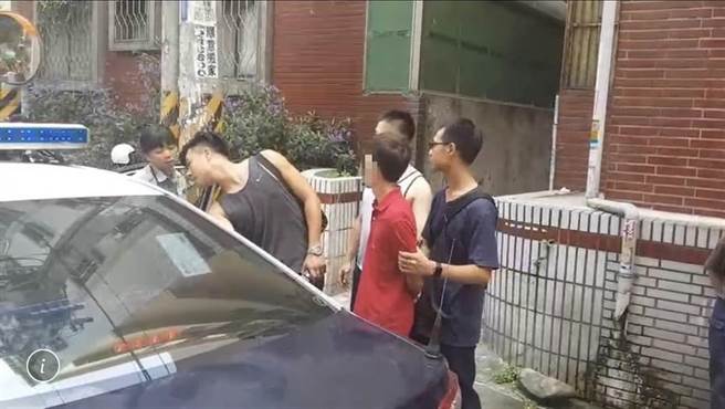 新竹市疑似虐童案在网路社群传开后，引发网友眾怒，还有民眾（红衣者）气的到男童生父租屋处丢鸡蛋，遭到警方逮捕。（陈育贤翻摄）