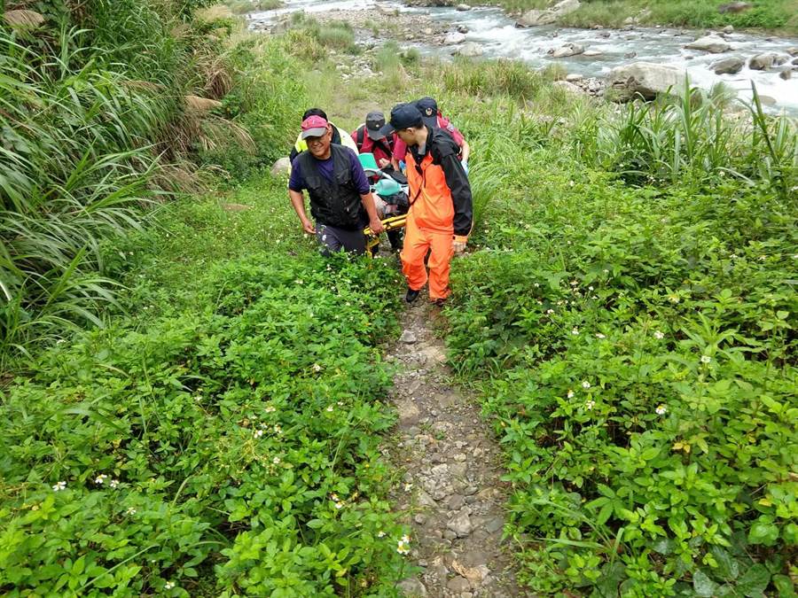 警消將溺水釣客抬上岸。（巫靜婷翻攝）