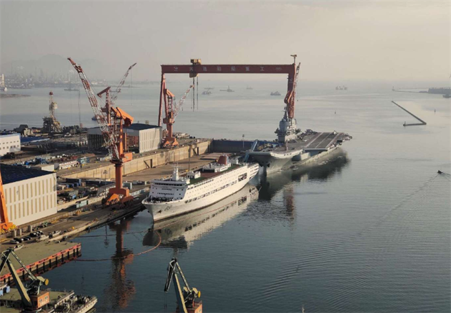 在大连造船厂停靠1个多月的解放军首艘自制航母002舰10月15日在拖船引导下，再次离港，展开第8次海试。（网路）