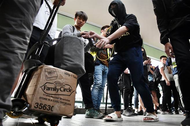 12月28日，有暴徒于上水聚集并于上水广场外天桥骚扰、推撞、辱骂旅客，多名旅客行李及货物被激进示威者扔到地上毁坏，有旅客受到惊慌于港铁站内寻求协助。（中新社／香港中通社图片）