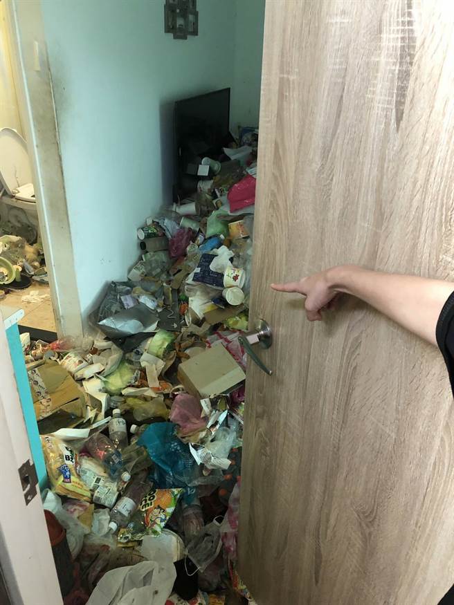 推開房門，地板全是垃圾，屋內髒亂不堪。(照片/板橋分局 提供)