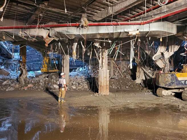 现场疑似8楼楼板坍塌，约100平方公尺的石块坠落到1楼，砸到1楼的一辆小山猫及小货车，消防人员到场开挖搜救。（民眾提供／林郁平台北传真）