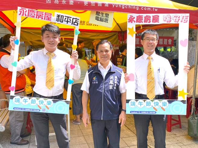 北市大安区龙生里举办端午佳节园游会，永庆房屋贴心准备拍照手举牌，方便民眾拍到过瘾。