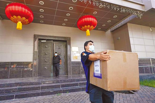 美國要中國大陸駐休士頓總領事館72小時內關閉，圖為聯邦快遞（FedEx）員工23日從總領館搬出紙盒的畫面。（美聯社）