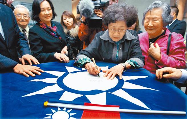 民进党以国徽党徽太相似，拟提案要求国民党修改党徽惹议。图为国民党庆祝中华民国100年时，邀请革命先烈陆皓东孙女陆淑贞（右）与秋瑾外孙女陈焱华（右二）观看史蹟及照片，在徽章上签名。（本报资料照片）