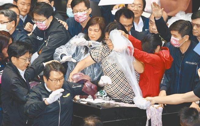 图为民进党立委王美惠(中)在立院大战中满身猪内臟。(图/本报资料照)