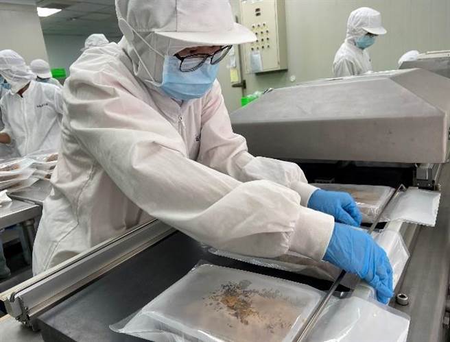 憨儿小梅操作真空封口机。（林雅惠摄）