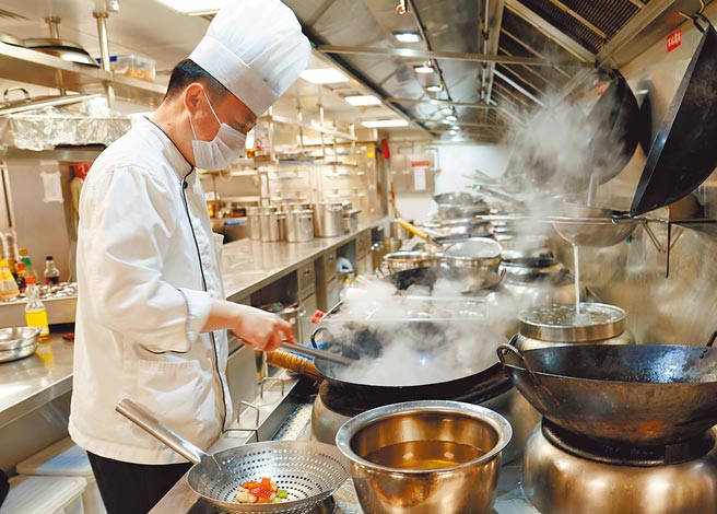 大陆反饮食浪费，餐饮业应更注意这部分风险。图为上海某餐厅后厨人员在烹制菜肴。（新华社）