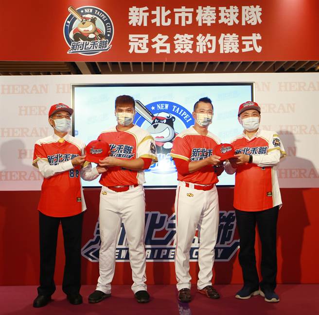 新北市长侯友宜（右）29日出席「新北市棒球冠名签约仪式」记者会，正式宣告自101年1月1日起新北市棒球队将以「新北禾联棒球队」亮相，侯友宜与禾联董事长蔡金土（左）致赠球帽给队员代表，教练周正雄（右2）与队长李君国（左2）。（陈信翰摄）