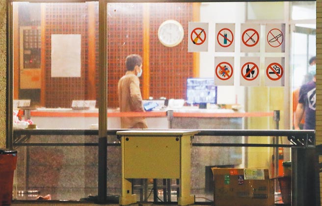 前晚從英國返台的旅客隨即入住集中檢疫所，由於同機有人確診，28日晚間，檢疫所一片燈火通明，一樓辦公室拉起了紅龍警戒。（季志翔攝）