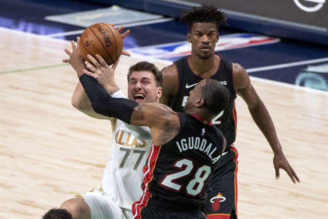 独行侠后卫东契奇在上篮时，遭到热火前锋伊戈达拉阻挡犯规。(美联社)