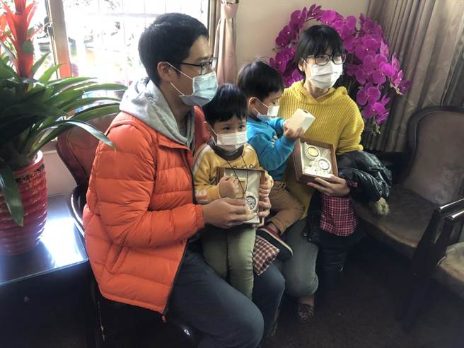 碰巧是1月2日生的苗栗妈妈（右），带着双胞胎到竹山参拜，幸运获得精装钱母套币；庙方特别加码送双胞胎一人一组葫芦套币，模样逗趣可爱。（竹山紫南宫提供／黄立杰南投传真）