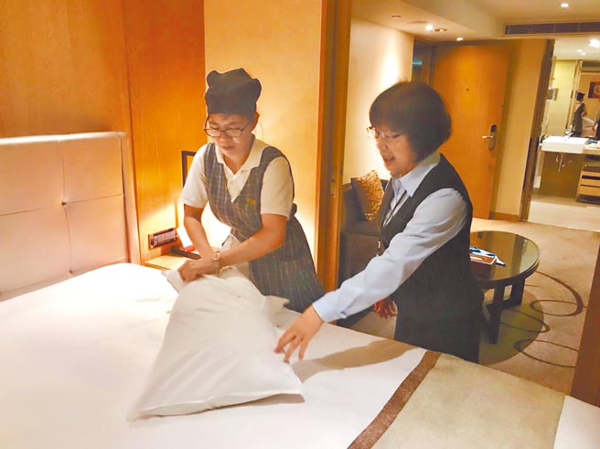 高雄翰品酒店資深員工（右）指導新人整理房務。（高雄翰品酒店提供／柯宗緯高雄傳真）
