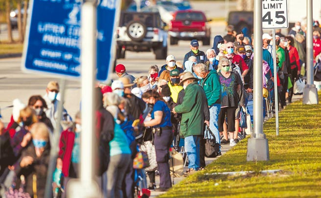 美国新冠疫情严重，近36万人丧命，图为佛罗里达州迈尔斯堡1处图书馆外，民眾大排长龙等候施打疫苗。（路透）