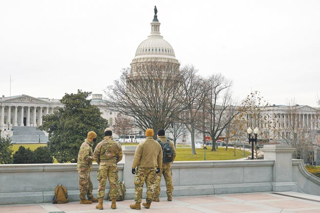 美國國會山莊6日遭川普支持者闖入大鬧後，五角大廈已派出數千名國民兵進駐華府維持秩序，圖為8日當天。國會山莊附近幾名軍方人員正維持警戒。（美聯社）