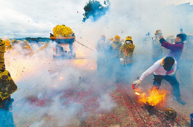 台東媽祖文化祭9日登場，北港朝天宮帶來傳統「犁炮」，由炮手利用火爐加熱的犁鐵點燃排炮，擲向神轎底。（莊哲權攝）