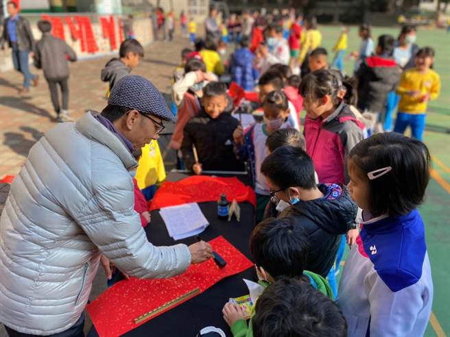 南屯学童展现书艺，启动牛年吉祥年画春联比赛，象徵「牛跃犁头，福耕南屯」的美好意象。（南屯国小提供）