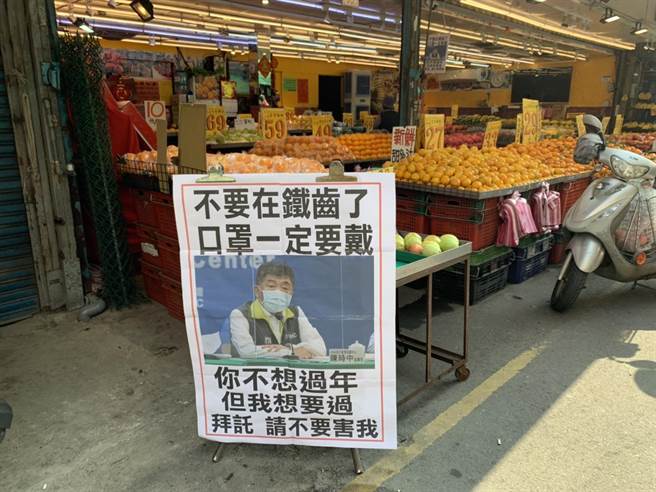 有水果摊自制看板，以指挥官陈时中照片写上「你不想过年，但我想过」，呼吁大家戴好口罩。(蔡依珍摄)