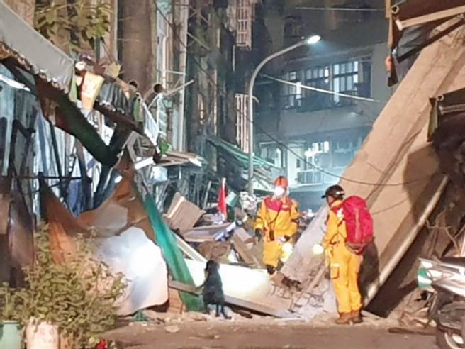 高市新興區一棟屋齡逾50年老屋，28日在地震過後外墻坍塌，消防局出動特搜中隊及搜救犬，經清查確定無人受困。（袁庭堯攝）