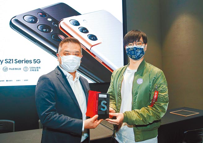 台湾三星电子行动与资讯事业部副总经理陈启蒙（左）与抢得第一梯次取机名额的消费者合照。（吴松翰摄）