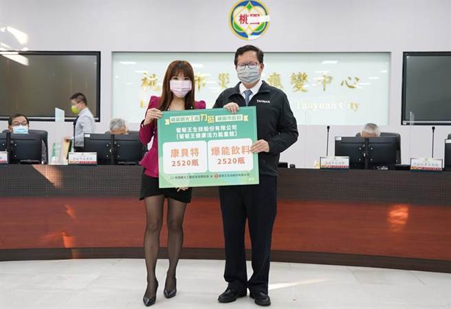 （葡萄王观光工厂提供共计5040能量饮料予桃园市政府。左为观光工厂苏家瑮馆长，右为桃园市长郑文灿。图／葡萄王提供）
