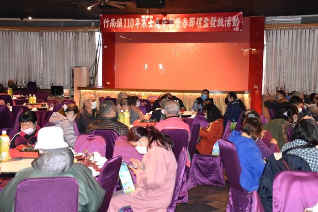 竹南鎮公所與善心人士2日中午在龍鳳漁港海鮮餐廳準備豐盛年菜招待鎮內弱勢住戶。（謝明俊攝）