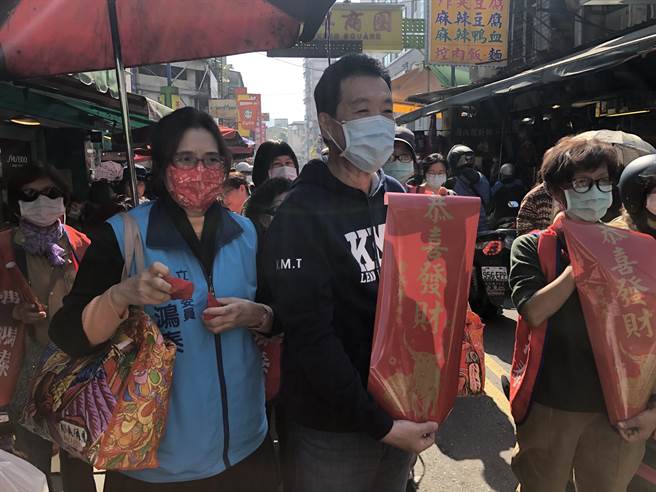 国民党团总召费鸿泰偕太太到吴兴市场发放春联。（赵婉淳摄）