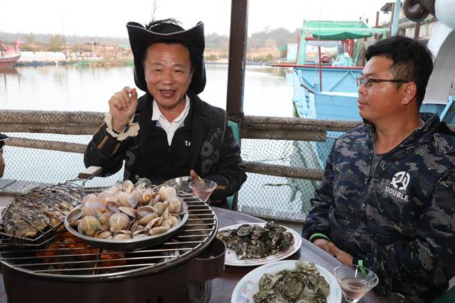 嘉义县长翁章梁装扮成海盗船长，在船屋大口大口的吃海鲜烧烤大餐。（吕妍庭摄）