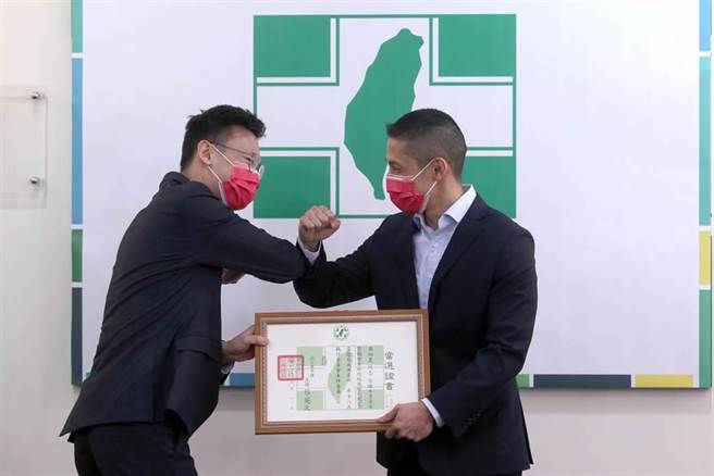 民進黨台北市黨部新任主委吳怡農（右）9日宣誓上任就職，從中央黨部副祕書長林飛帆（左）手中接過當選證書，兩人互碰手肘致意。（黃世麒攝）
