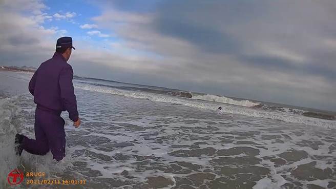警方在后湖海滩发现下半身已泡在水中的吴女，赶紧衝进大海救人。（警方提供）