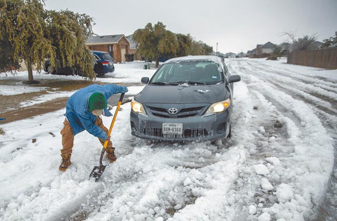 冬季风暴侵袭，受创严重的德州连日出现大停电。图为铲雪的民眾。（美联社）