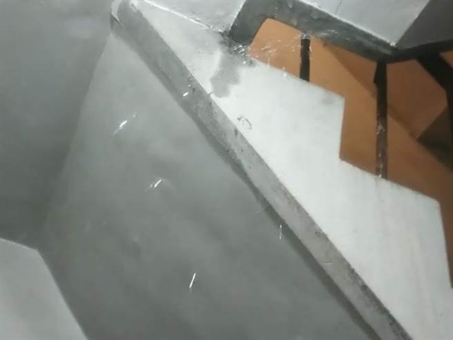 基隆某公寓4樓住戶門縫持續流出大量的水，造成樓下住戶家中及大樓樓梯間嚴重淹水。（基隆市警局提供／陳彩玲基隆傳真）