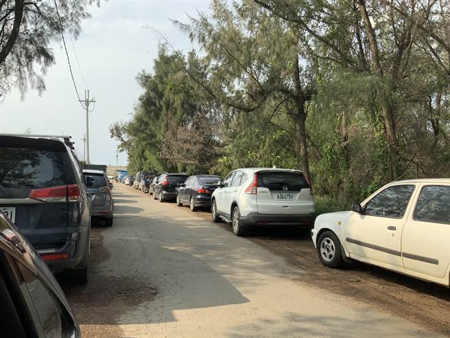 大潭藻礁管制區外排滿了釣客車輛，根據警衛敘述約有60名釣客。（姜霏攝）