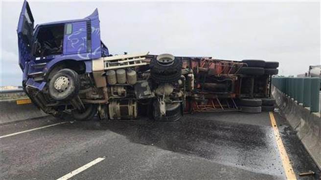 大货车疑爆胎自撞护栏翻覆，横躺西滨台中大安段，阻断南下全线交通。（民眾提供／王文吉台中传真）