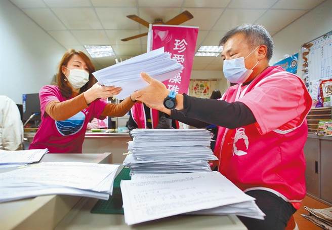 針對藻礁公投連署盛況不斷升高，在環團藻礁公投總部內，身穿粉色上衣的志工正忙著清點連署書。（范揚光攝）