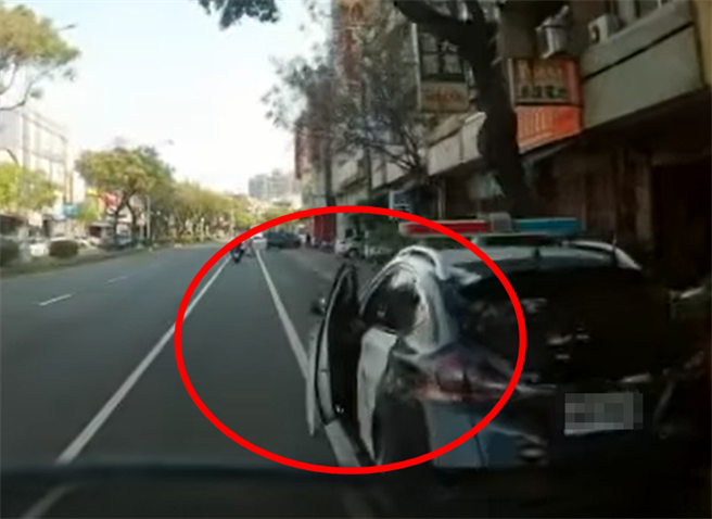 一名女網友8日騎車行經台中市潭子區某路段時，遇上一名警察未兩段式開門，險險害她摔倒在地，紅圈處可見警車車門開啟。（翻攝照片）