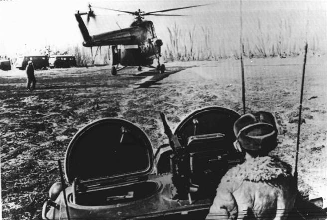 一九六九年三月中共和蘇聯邊界衝突期間檔案照片,在中俄邊界的烏蘇里江邊一名登上裝甲車的蘇聯士兵,正注視一架著陸的直升機。（本報系資料照片）