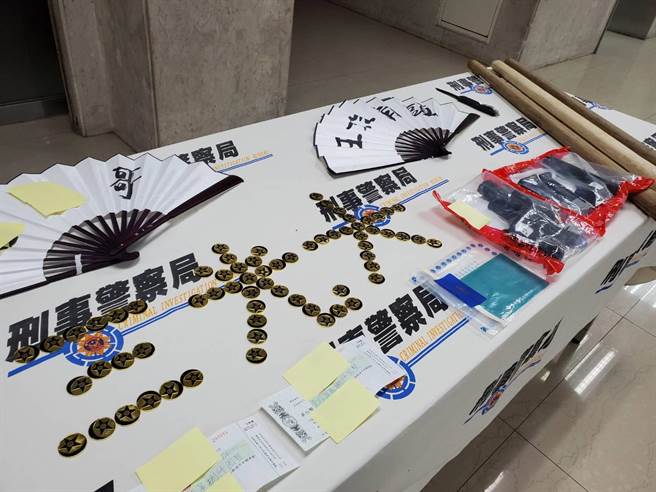 警方查扣到空气枪2把、帮派识别标志94枚、弹簧刀、棍棒、纸扇、本票等赃证物。(林郁平摄)
