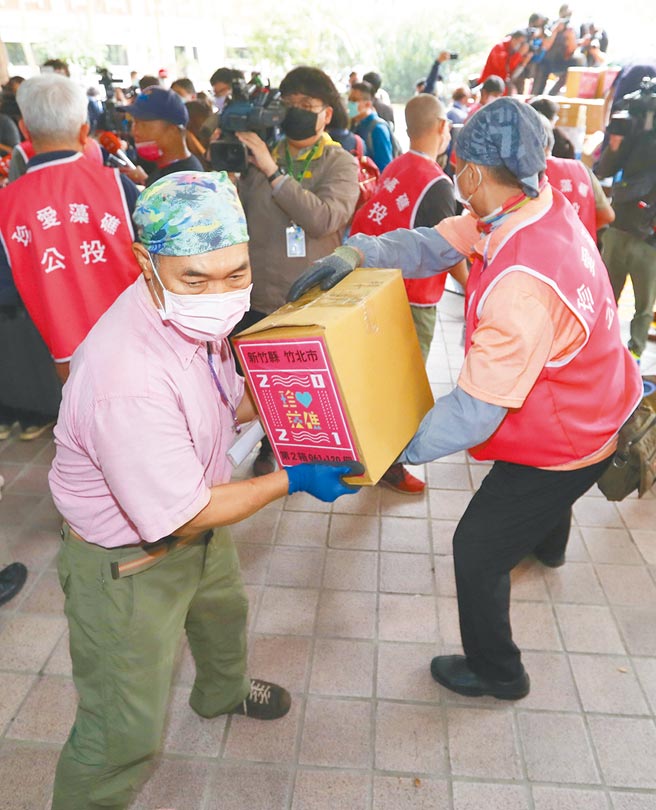 珍爱藻礁公投工作小组18日将70万3052份藻礁公投连署书送达中选会，工作小组人员排成人龙，合作协力地将一箱一箱的公投连署书搬进中选会。（刘宗龙摄）