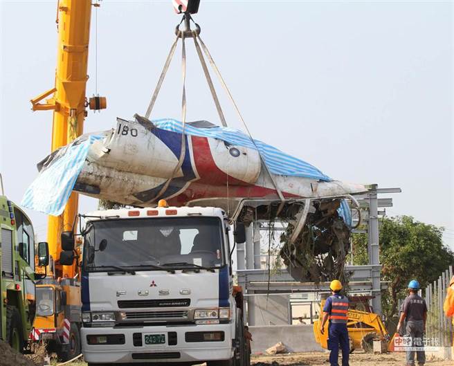 空军AT-3教练机在演练时发生坠机意外，驾驶庄倍源中校罹难，军方人员将坠落的飞机机身残骸吊挂上拖车准备拖离。(图／中时资料照)