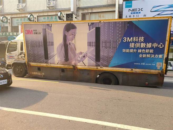 大货车左后轮卡在凹洞内动弹不得。（姜霏摄）
