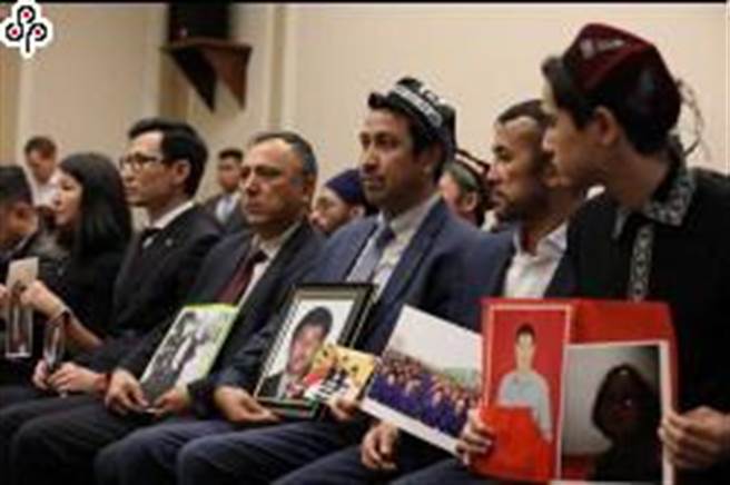 中国外交部发言人宣布对美国加拿大有关人员和实体实施制裁。图为2019年12月多名出席美国国会听证会的维吾尔族人手持被拘禁在新疆家人照片，盼外界协助。（中央社）