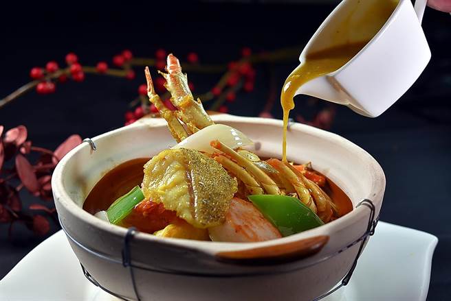 传统港式「煲仔菜」的咖哩味型，多是以虾、蟹配咖哩，寒舍艾美酒店〈寒舍食谱〉的〈龙虾咖哩海味煲〉则以龙虾与龙虎斑入馔，并刻意减少椰浆与奶汁比例，凸显咖哩风味。（图／姚舜）