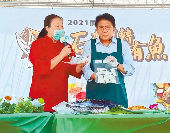 屏东县长潘孟安（右）也现场下厨烹煮石斑鱼料理，并大啖各种鲜鱼美食。（潘建志摄）