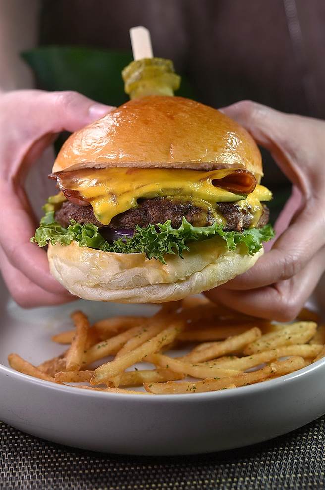 〈M One Cafe〉的〈酪梨起司培根牛肉漢堡〉內容豐富，為許多飲食男女到店必點的「鎮店之堡」。（圖／姚舜）