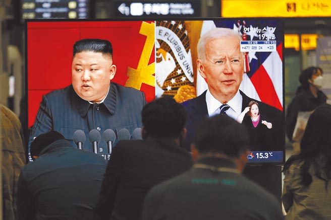 3月26日，韓國首爾火車站的大電視上播放新聞，出現美國總統拜登（右）與朝鮮最高領導人金正恩「同框」的畫面。（美聯社）