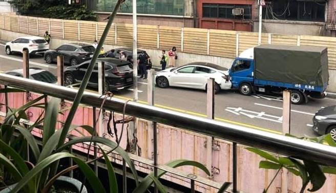 一台特斯拉在基隆東岸高架遭追撞，車尾凹毀女駕駛背痛搭警車送醫。（圖／陳彩玲翻攝）