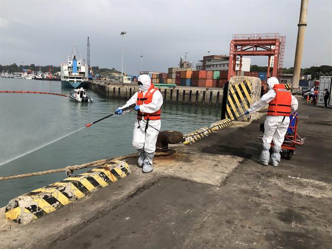 救灾人员紧急消除油污，减低海洋生态破坏。（李金生摄）