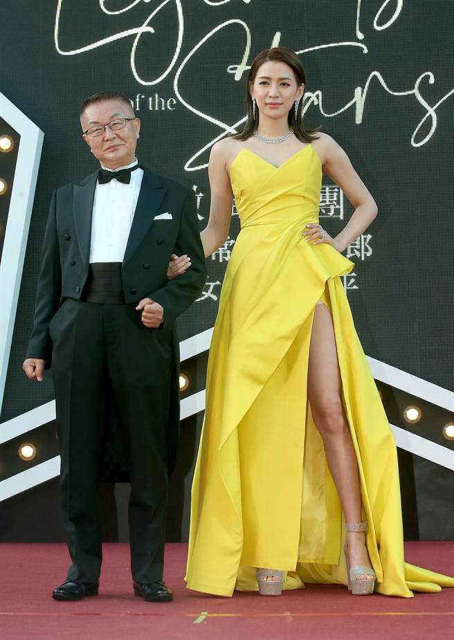 微风执行常董冈一郎（左）穿燕尾服，同行的王思平（右），去年8月产女后首次公开露面，辣穿左腿开高叉、亮黄色长礼服。（粘耿豪摄）
